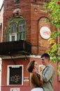 Love story of stylish funny couple: young man in a t-shirt. And a cute young woman in white skirt