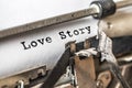 Love story typed words on a vintage typewriter. Close up Royalty Free Stock Photo