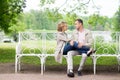 Love story, young couple on bench. Romance relationship Royalty Free Stock Photo