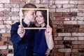 Love story. Young, loving couple, The guy with the girl holding the frame from the picture Royalty Free Stock Photo