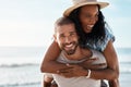 Love is such a blissful feeling. Portrait of a young man piggybacking his girlfriend at the beach. Royalty Free Stock Photo