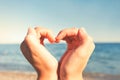 With love from summer! Heart shaped young lady`s hands