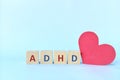 Love and support kids with ADHD or attention deficit hyperactivity disorder concept. ADHD letters on wooden blocks.