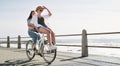 Love is supposed to be filled with fun and happiness. Full length shot of a happy young couple riding a bicycle together Royalty Free Stock Photo