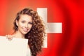 Love Switzerland concept. Happy beauty woman with white paper on swiss flag background Royalty Free Stock Photo