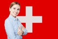 Love Switzerland. Happy smiling woman on swiss flag background Royalty Free Stock Photo