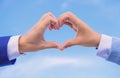 Love symbol concept. Hands put together in heart shape blue sky background. Male hands in heart shape gesture symbol of Royalty Free Stock Photo