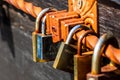 Love symbol, old rusty padlocks hanging on wooden fortress bridge in Alba Iulia, Romania, 2021