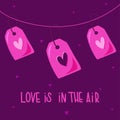 Love tags on a thread with a heart for Valentines Day postcards. Love is in the air