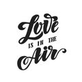 `Love is in te air` lettering inscription isolated on white background. Handwrittster or greeting card. Royalty Free Stock Photo