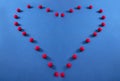 For the love of tennis. multiple tennis balls forming a heart shape on a blue tennis court. Royalty Free Stock Photo