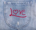 Love text on denim blue jeans background Royalty Free Stock Photo