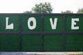 Love text on green door background.