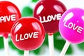 Love and Love text on red lollipops on white background