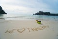 We love Thailand - text written by hand in sand on a sea beach with kayak over sky. Royalty Free Stock Photo