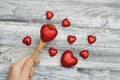 Love Theme: hand of a Little Girl Holding a Red Heartin Spoon isolated on Gray Rustic Background Royalty Free Stock Photo