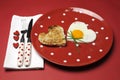 Love theme Valentine breakfast on red polka dot plate Royalty Free Stock Photo