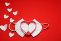 Love in times of pandemic and covid, kn95 protection mask with hearts on red background, Valentine`s day