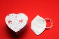 Love in times of pandemic and covid, kn95 protection mask with hearts on red background, Valentine`s day