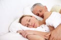 Love, tired and mature couple sleeping in bed for cuddling together on weekend morning at home. Calm, peaceful and man Royalty Free Stock Photo