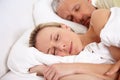 Love, tired and mature couple sleeping in bed for romantic cuddling together on weekend morning. Calm, peaceful and Royalty Free Stock Photo