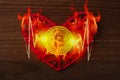 Love to bitcoins. Coin Bitcoin lies on a red heart in a flame of fire