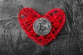 Love to bitcoins. Coin Bitcoin lies on a red heart