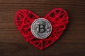 Love to bitcoins. Coin Bitcoin lies on a red heart