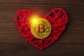 Love to bitcoins. Coin Bitcoin lies on a red heart