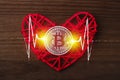 Love to bitcoins. Coin Bitcoin lies on a red heart