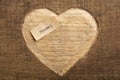 Love to travel concept. Travel - tiny typed text note close up, carved heart shape on wood as a background Royalty Free Stock Photo