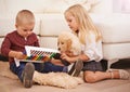 They love together, they play together. A brother and sister playing with their puppy at home.