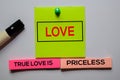 Love. True Love Is Priceless text on sticky notes isolated on office desk