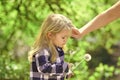 Love and trust concept. Baby blow dandelion and female hand tidy child hair Royalty Free Stock Photo