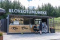 Love Tumuheke cafe stop on Huka falls Walking Track with three patrons and Kia Ora of welcome sign