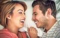 Love turns me into we. a happy young couple lying face to face with each other in bed. Royalty Free Stock Photo