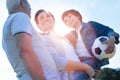 Cheerful family discussing soccer after playing outdoors Royalty Free Stock Photo