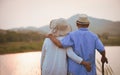 Love and Valentine day concept. A happy senior couple standing near mountain and lake during sunset , Senior healthcare and Royalty Free Stock Photo
