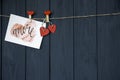 Love Valentine`s card `Amore` natural cord and red pins hanging on rustic Driftwood texture background, Copy Sp