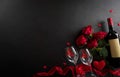 Love and Valentine`s day concept made from champagne glasses , wine, red hearts and rose on black wooden background. Top view wit Royalty Free Stock Photo