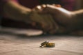 Love, Valentine`s day and wedding concept. Two wedding rings with man and woman hands blurred in the background. Selective focus Royalty Free Stock Photo