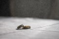 Love, Valentine`s day and wedding concept. Two wedding rings with man and woman hands blurred in the background. Selective focus Royalty Free Stock Photo