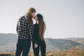 Love and valentines concept. Teenager lovers couple over natural background at the mountain and holding hands looking in Royalty Free Stock Photo