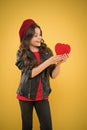 Love. valentines day. child on yellow wall. small girl kid with long curly hair. happy girl in french beret and leather