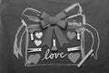 Valentines decorations and symbols on black background. Love and Valentines day concept. Present drawn on black board