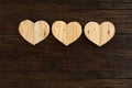 Love Valentines wooden hearts on rough driftwood background Royalty Free Stock Photo