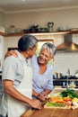 Love, vegetables and old man with happy woman at kitchen counter, embrace and healthy marriage bonding in home