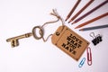 Love what you have. Price tag with text and golden key on white background