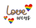 Love wins rainbow phrase lettering. Colorful hand drawn LGBT quote and hearts isolated. Vector text illustration