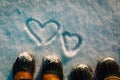 Love winter concept - feet in snow boots and heart in nature Royalty Free Stock Photo